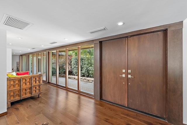 doorway to outside with hardwood / wood-style flooring, visible vents, and recessed lighting