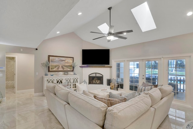 living room featuring french doors, high vaulted ceiling, a skylight, and ceiling fan