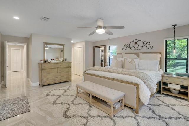 bedroom featuring a textured ceiling and ceiling fan