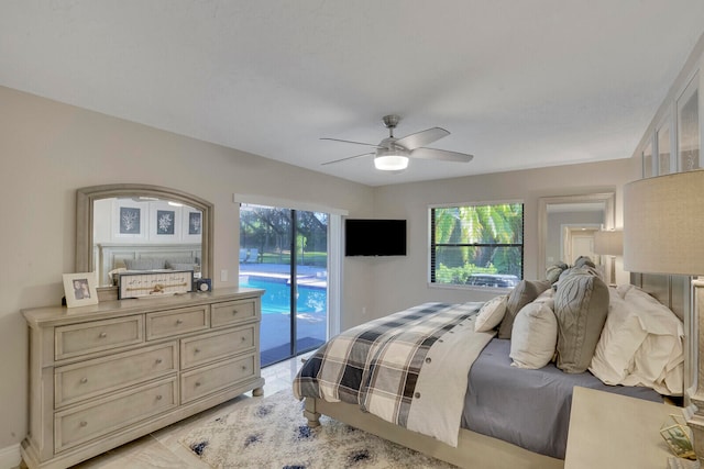 bedroom featuring access to exterior, multiple windows, and ceiling fan