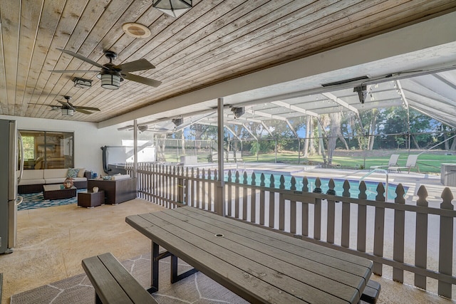 view of patio / terrace with ceiling fan, glass enclosure, and an outdoor hangout area