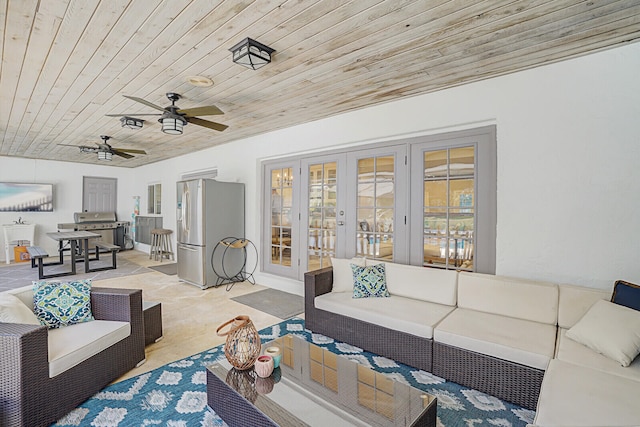 living room with french doors, wood ceiling, and ceiling fan