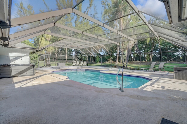 view of swimming pool with a patio area and a lanai