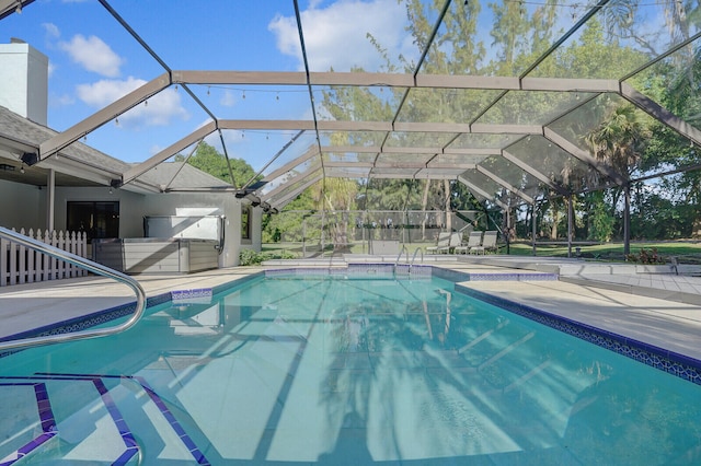 view of swimming pool featuring a patio area and a lanai