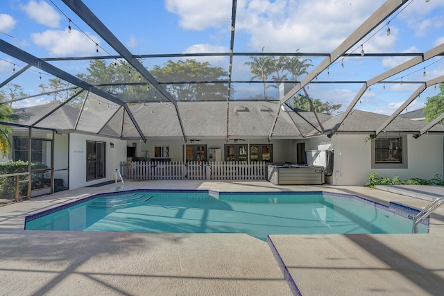 view of swimming pool with a patio area and glass enclosure