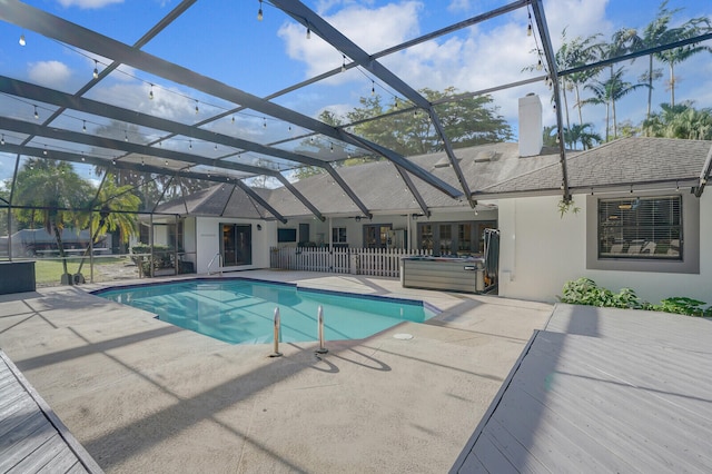 view of pool with a patio and glass enclosure