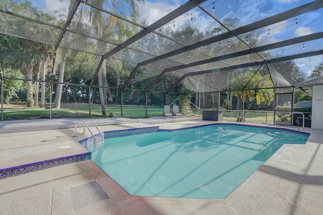 view of swimming pool with a patio and glass enclosure