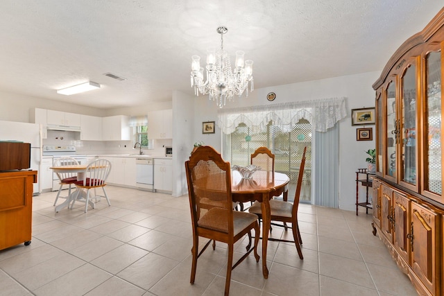 dining space featuring a wealth of natural light, an inviting chandelier, and light tile patterned floors