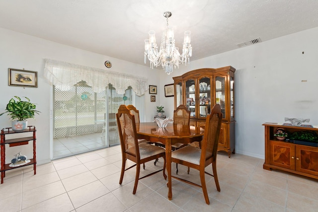 tiled dining room featuring a notable chandelier