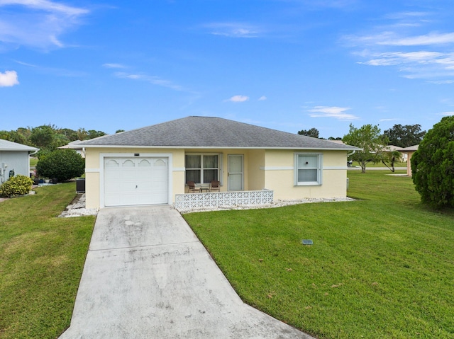 single story home with a garage and a front lawn