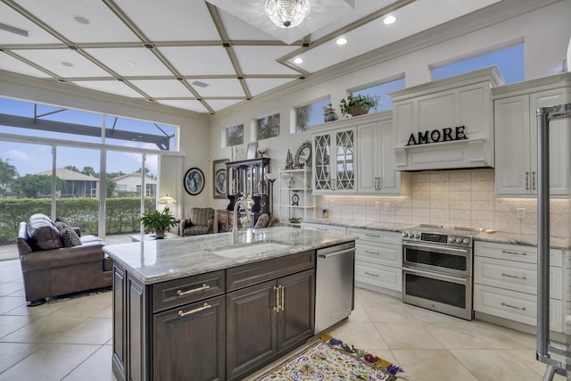 kitchen featuring dark brown cabinets, appliances with stainless steel finishes, sink, and white cabinets