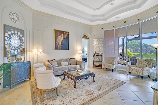 living room with a towering ceiling, crown molding, and light tile patterned flooring