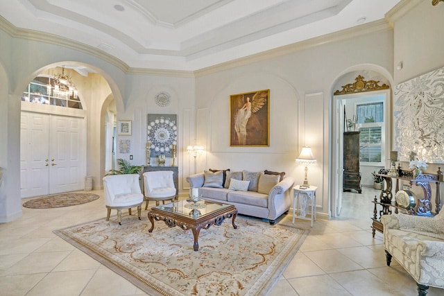 living room featuring crown molding, a towering ceiling, and light tile patterned floors