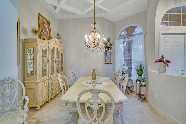 tiled dining room with beamed ceiling, coffered ceiling, a notable chandelier, and a high ceiling