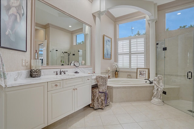 bathroom featuring vanity, ornamental molding, separate shower and tub, and decorative columns