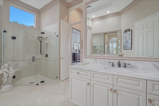 bathroom with vanity, crown molding, walk in shower, and tile patterned flooring