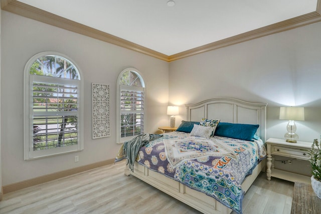 bedroom featuring crown molding and light hardwood / wood-style flooring