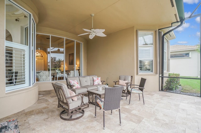 sunroom / solarium featuring ceiling fan and plenty of natural light