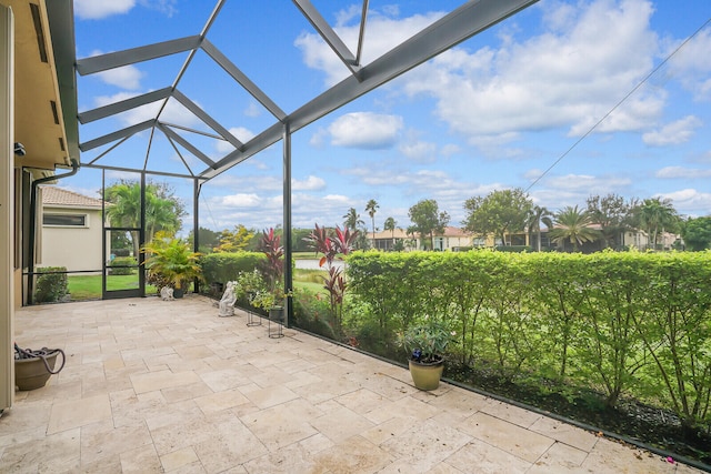 view of patio featuring a lanai