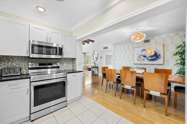 kitchen featuring white cabinetry, light hardwood / wood-style flooring, and stainless steel appliances