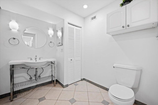 bathroom featuring tile patterned flooring and toilet