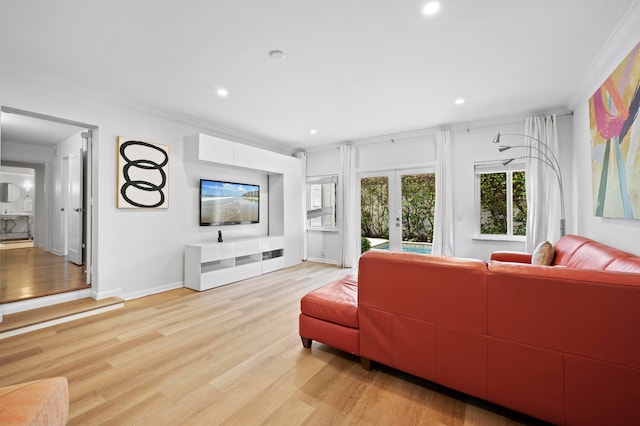 living room with light wood-type flooring, crown molding, and french doors