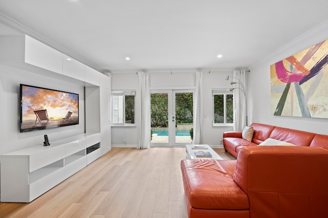 living room with french doors, ornamental molding, and light hardwood / wood-style flooring