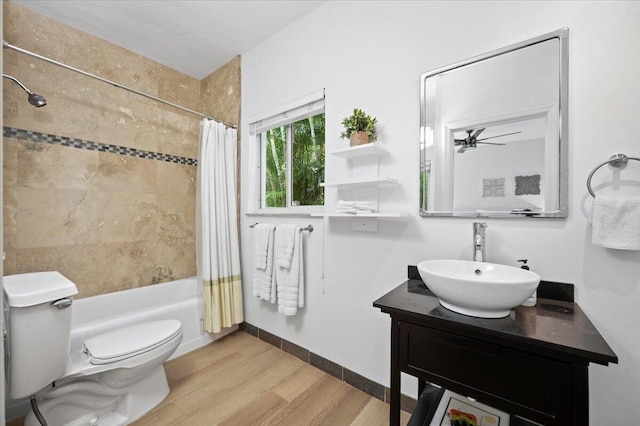 full bathroom with vanity, ceiling fan, toilet, wood-type flooring, and shower / tub combo