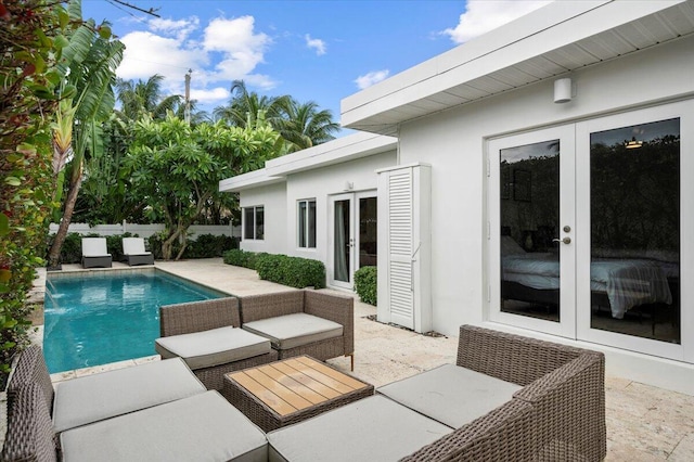 view of pool featuring pool water feature, a patio area, an outdoor hangout area, and french doors