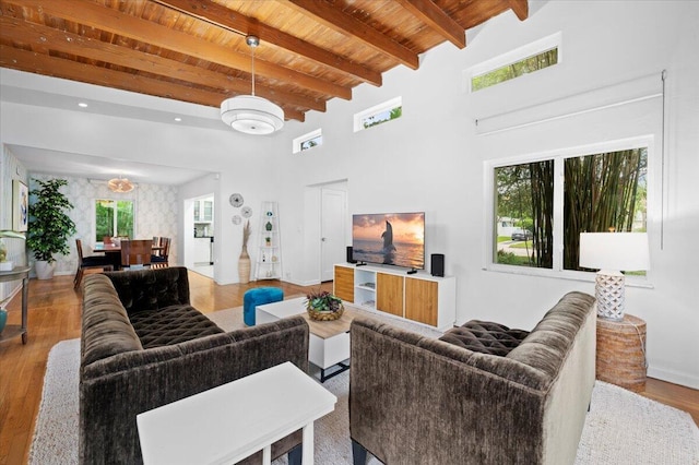 living room with beamed ceiling, light wood-type flooring, and wooden ceiling