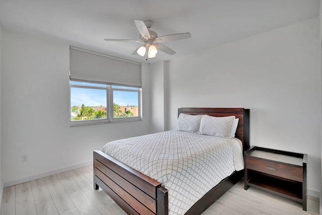 bedroom with light hardwood / wood-style floors and ceiling fan