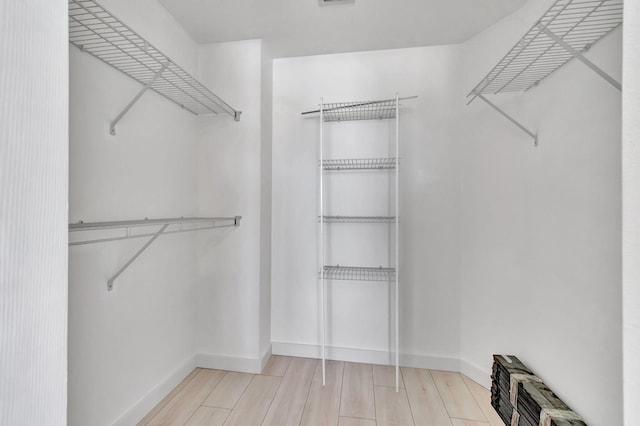 spacious closet featuring hardwood / wood-style floors