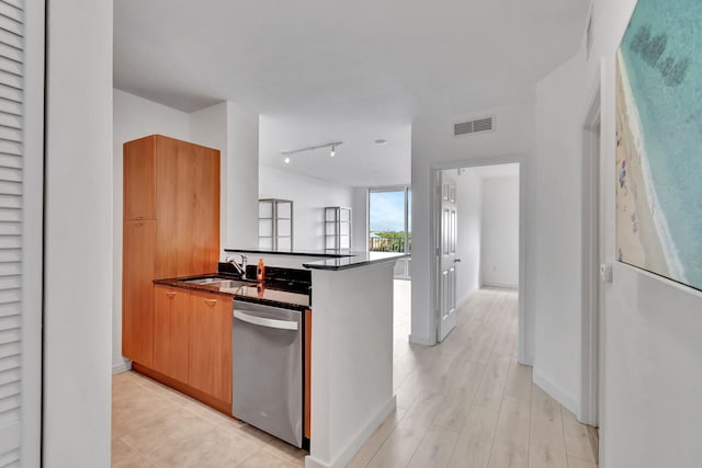 kitchen featuring sink, dishwasher, kitchen peninsula, light hardwood / wood-style floors, and track lighting