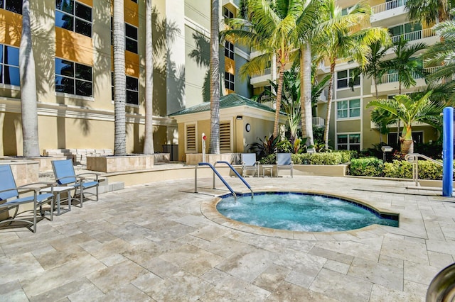 view of pool featuring a patio and a hot tub