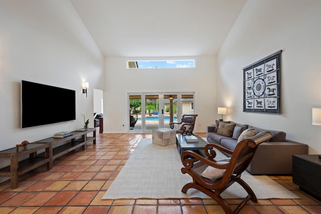 tiled living room with high vaulted ceiling and french doors