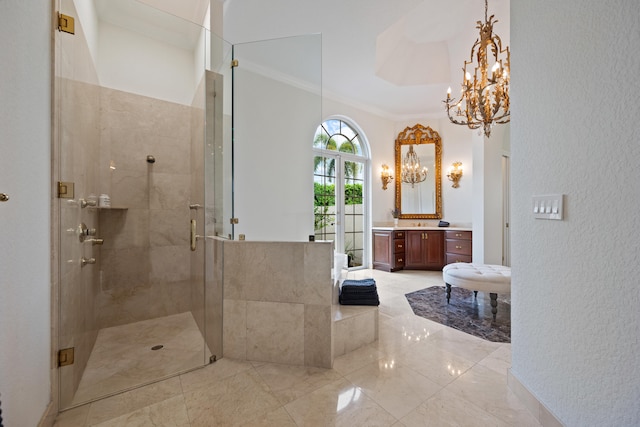 bathroom with a chandelier, vanity, a shower with door, and crown molding