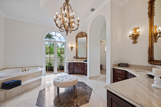 bathroom with a towering ceiling, vanity, tiled bath, and ornamental molding