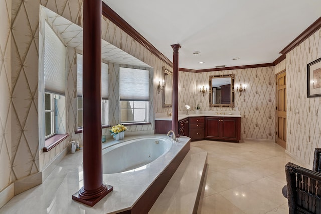 bathroom featuring decorative columns, crown molding, a washtub, and vanity