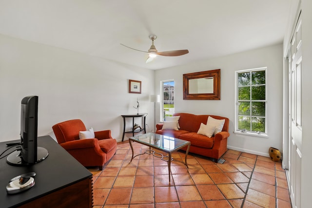 living room with ceiling fan, a healthy amount of sunlight, and light tile patterned flooring