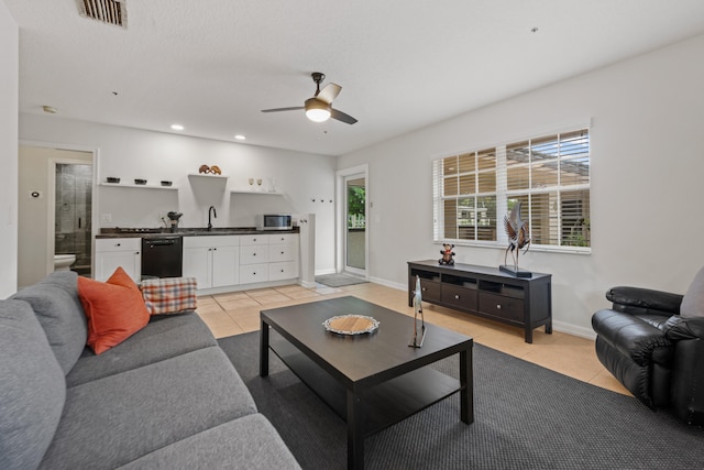 tiled living room featuring a textured ceiling and ceiling fan