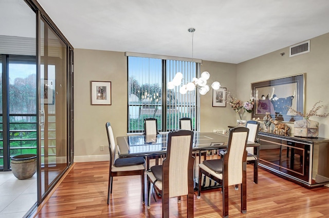 dining area with a notable chandelier and wood-type flooring