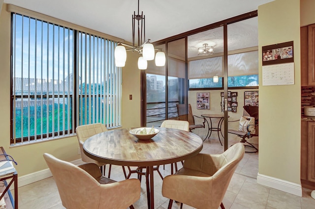 dining room featuring an inviting chandelier, a healthy amount of sunlight, and light tile patterned floors