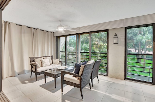 sunroom / solarium featuring a healthy amount of sunlight and ceiling fan