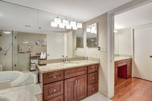 bathroom featuring vanity, independent shower and bath, and wood-type flooring