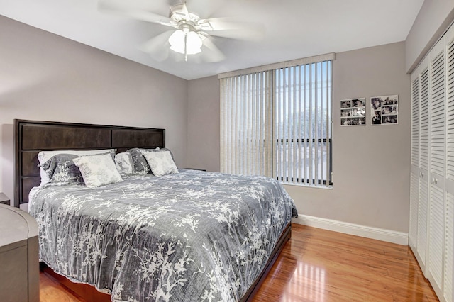 bedroom featuring hardwood / wood-style floors, a closet, and ceiling fan