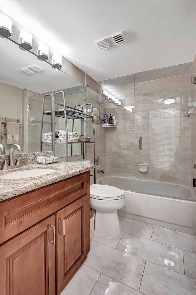 full bathroom with vanity, enclosed tub / shower combo, toilet, and tile patterned flooring