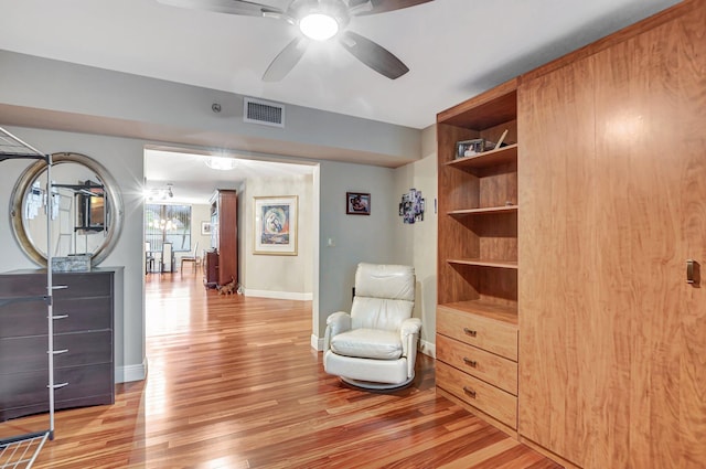 sitting room featuring light wood-type flooring and ceiling fan