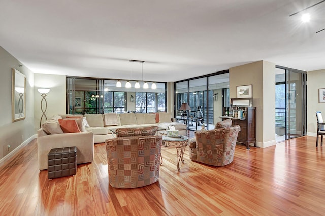 living room featuring light hardwood / wood-style floors and floor to ceiling windows