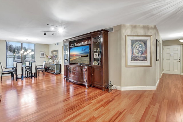 living room with a chandelier and wood-type flooring