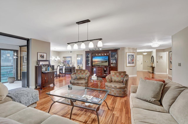 living room with a notable chandelier and hardwood / wood-style floors